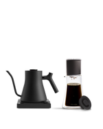 Fellow The Signature Brew Kit: black electric kettle & glass coffee set on white background.