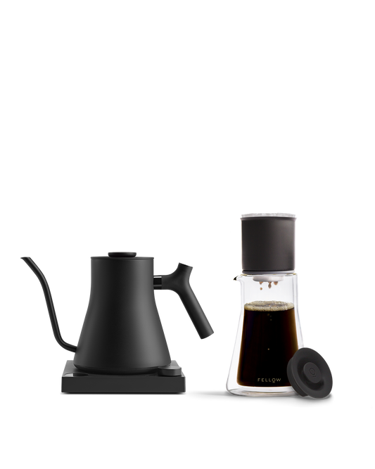 Fellow The Signature Brew Kit: black electric kettle & glass coffee set on white background.